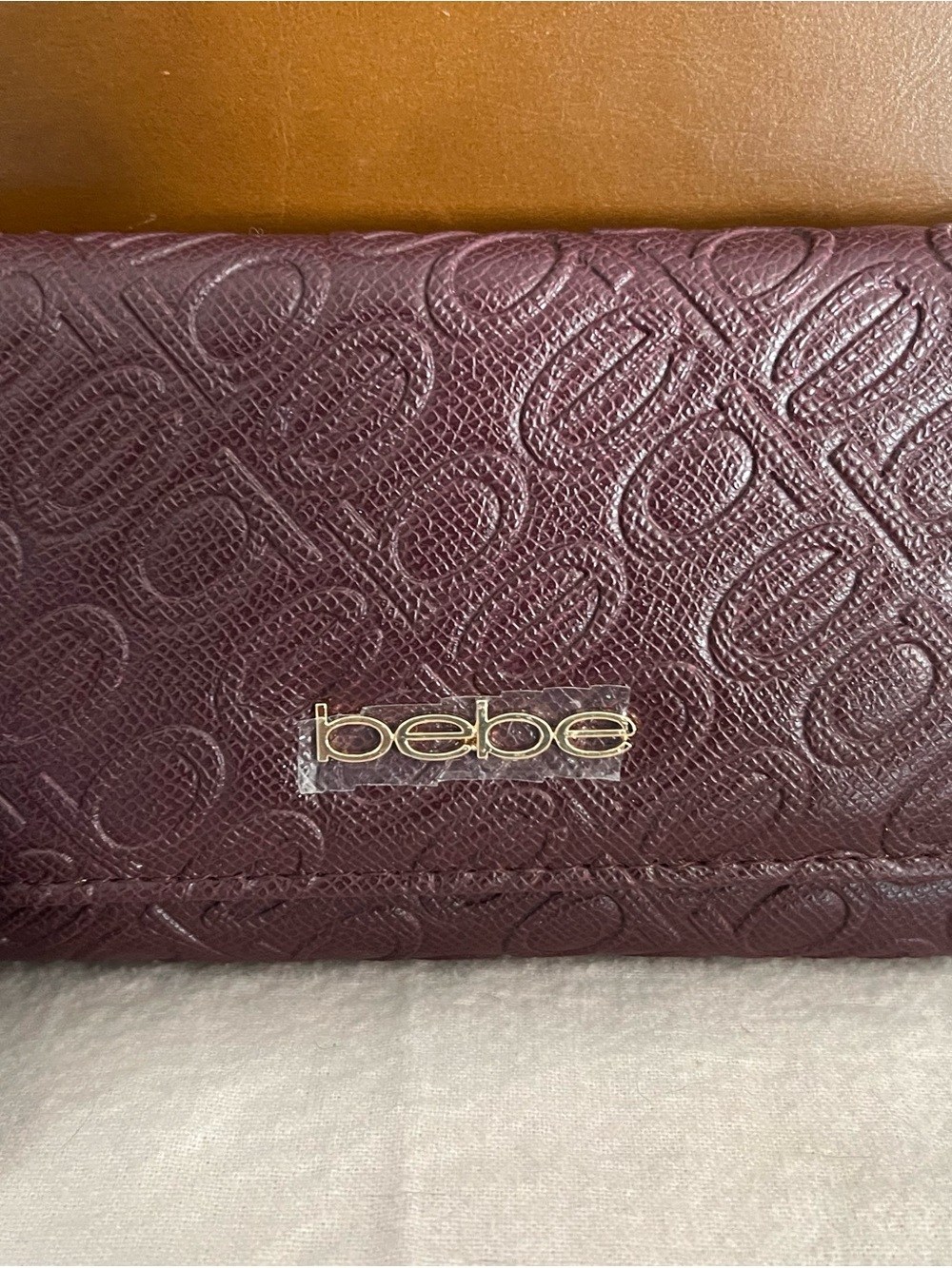 bebe Embossed Maroon Clutch Wallet with Gold Logo